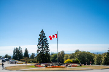 Fototapeta premium A picture of a Canadian flag taken with tilt-shift effect. Burnaby BC Canada 