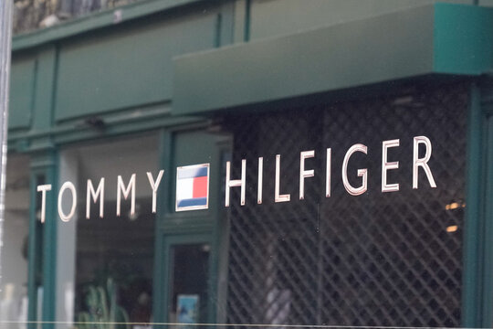 tommy Hilfiger sign flag and text logo store front of American clothing company fashion men shop