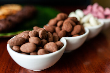 Almond nuts in dark, milk chocolate. 