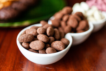 Almond nuts in dark, milk chocolate. 