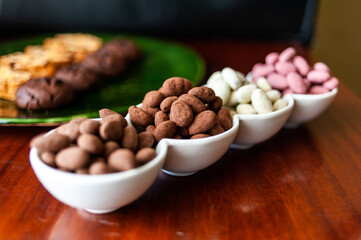 Almond nuts in dark, milk chocolate. 