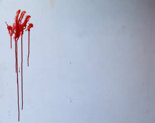 A red handprint, possibly blood, or possibly paint, on a grimy wall