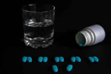 
Tablets with a glass of water and packaging