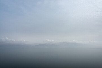 Obraz na płótnie Canvas Mountainous shore of the Dead Sea hidden by a haze.