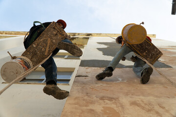 two guys painting a wall 