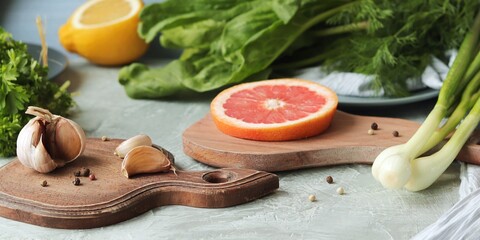 Fresh organic greens for cooking lunch, citrus fruits, spices on the table, healthy food, home seasonal cuisine