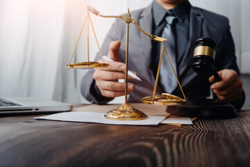 Justice and law concept.Male judge in a courtroom with the gavel, working with, computer and...