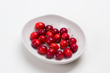 Small red apples in white bowl