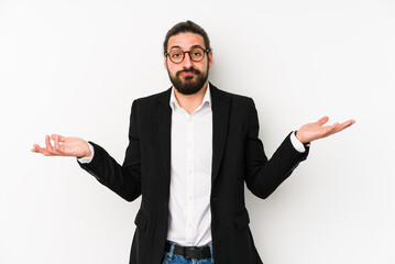 Young caucasian business man isolated on a white background doubting and shrugging shoulders in...