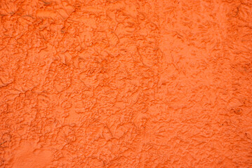 Orange textured wall background with irregular shapes