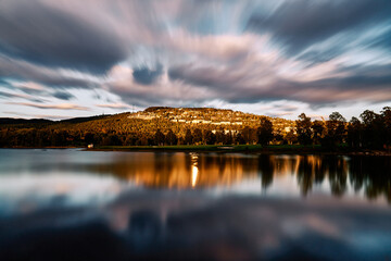 Holmenkollåsen from the Bogstadvannet. Shot at the evening and the natural sun light is...