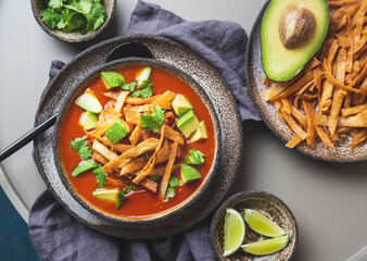Mexican style table with spicy aztec soup with fried tortilla. Sopa azteca - obrazy, fototapety, plakaty