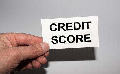 Message on the card CREDIT SCORE, in hands of businessman.