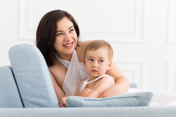 happy family in living room - woman and baby boy communicating