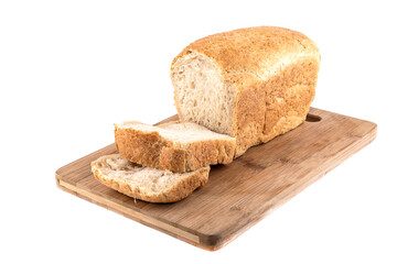 Loaf of wheat bread on a cutting board with roughly cut pieces.