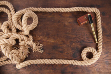 Strong Rope Frame with golden Telescope on wooden Background