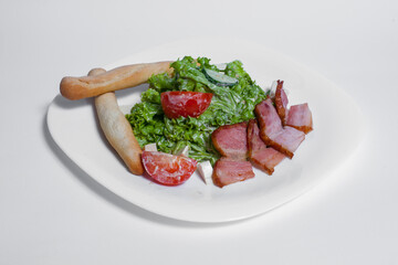 fresh salad with tomato, lettuce and grilled bacon on white background