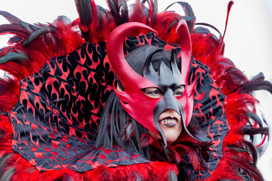 Woman wearing red and black carnival costume of vampire