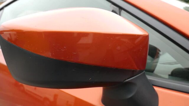 Flashy red GT toyota car left mirror sliding shot closeup 