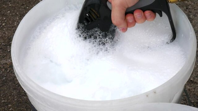 Static shot for a high pressure water pistol dipped in water wash bucket creating turbulence.