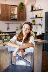 girl stands in the dining room