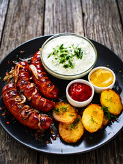 Grilled sausages on wooden board
