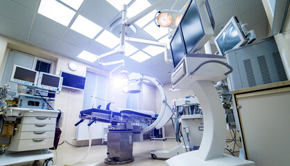 Clinic interior with operating surgery table, lamps and ultra modern devices, technology, hi-tech interior, medicine concept