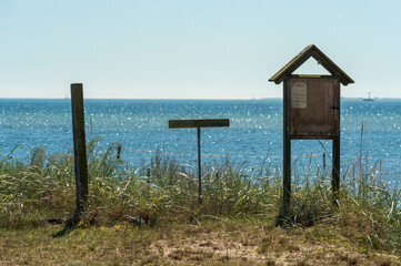 wooden signpost on the beach