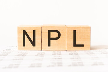 Word npl. Wooden small cubes with letters isolated on white background with copy space available.Business Concept image.