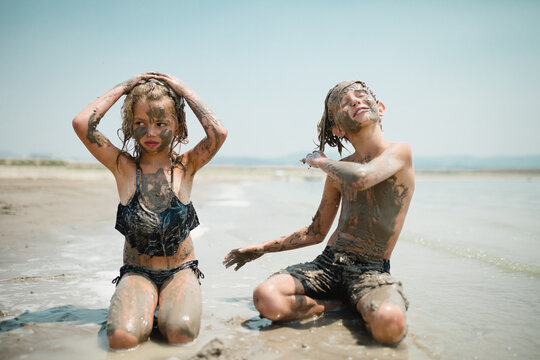 Kids Playing In Mud At The Beach
