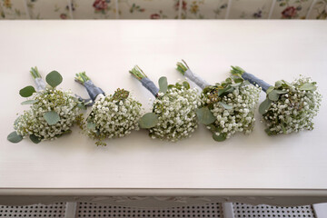Beautiful bouquets for bridesmaids from gypsophila flowers on a wooden table. The concept of...