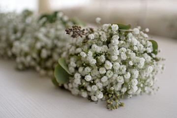 Beautiful bouquets for bridesmaids from gypsophila flowers on a wooden table. The concept of...