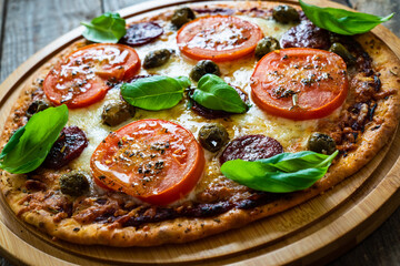 Margherita pizza on wooden background
