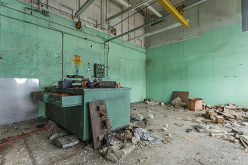 Fototapeta na wymiar Wide angle view of an empty laboratory covered in dust and dirt in an abandoned factory in the deep south