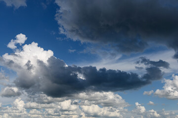 Naklejka na ściany i meble Sky panorama with gray dark thunderclouds before rain or storm. 