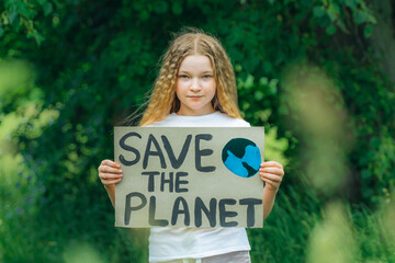 teenager looking to camera with save planet ecology poster in hands. school girl kid voted for...