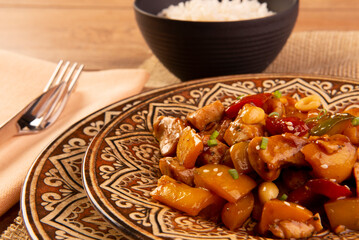chess chicken in brown dish on wooden background - chinese food