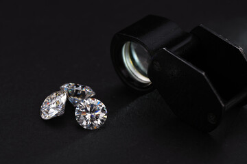 Round cut diamonds and jewelry loupe