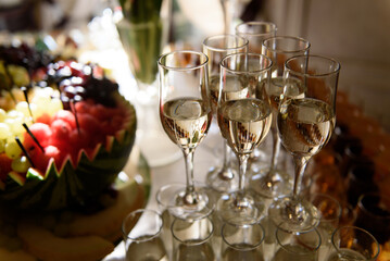 Champagne glasses on a festive cocktail table at a party