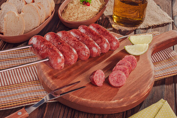 Grilled Sausage skewer on wooden board - Brazilian barbecue