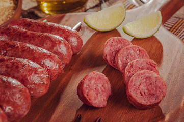 Slices grilled sausage on wooden board - Brazilian barbecue