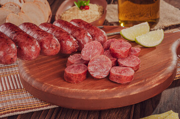Grilled sliced ausage on wooden board - Brazilian barbecue