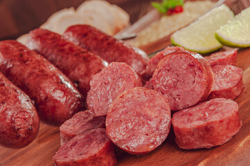 Grilled sliced ausage on wooden board - Brazilian barbecue