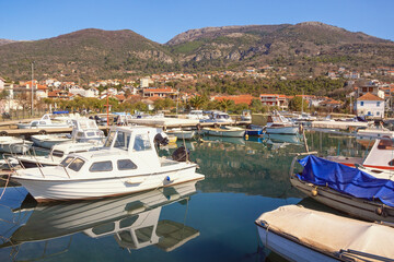 Fototapeta na wymiar Beautiful winter Mediterranean landscape. Fishing boats in harbor. Montenegro, Tivat city, view of marina Kalimanj