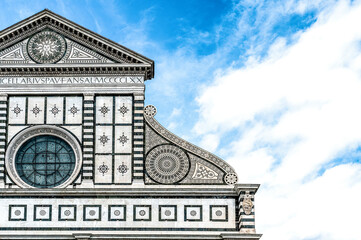Close-up of the façade of the Basilica of Santa Maria Novella in Florence, Italy, with its white marble facade in Renaissance style.