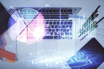 Multi exposure of forex graph drawing over desktop background with computer. Concept of financial analysis. Top view.