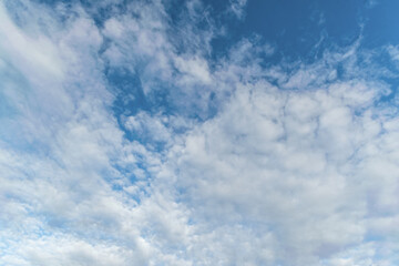 abstract background of white fluffy clouds on a bright blue sky
