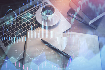 Stock market graph and top view computer on the table background. Multi exposure. Concept of financial education.