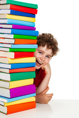 Boy behind pile of books isolated on white background
