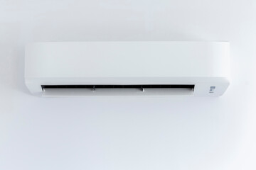 White air conditioner hanging on white wall